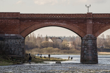 Long brick bridge and fishermans, Kuldiga, Latvia.