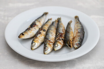 fried sardines on white small dish