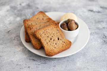 toasts with cheese on white small plate