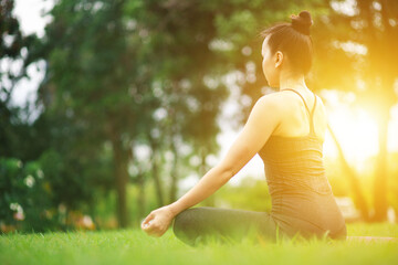 young woman doing yoga outdoor exercise morning sunrise for meditation and relaxation  concept of health care