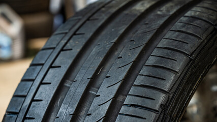 Close-up of a new car tire with a tread.