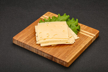 Sliced yellow cheese over board