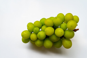 Fresh ripe juicy sweet green grapes  brunch fruit on isolated white background.