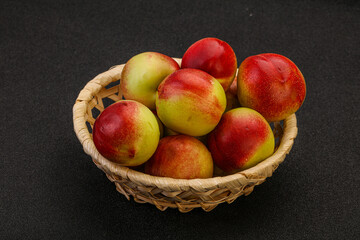 Sweet small nectarines in the basket