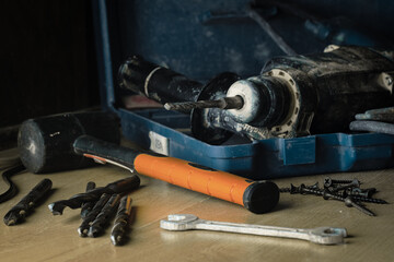 The puncher is in a drawer among other tools that are useful in repair or construction