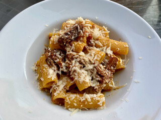 Rigatoni Pasta Alla Genovese, a typical Neapolitan Recipe with Parmesan Cheese, Onions and Meat in an Italian Restaurant.