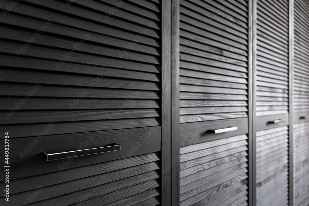 Wall mural Close-up of a textured wooden black cabinet.