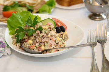 A table with dishes of food for the reception of guests. Festive eating at a banquet party.