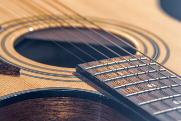 Fototapeta premium Close-up of a classical acoustic guitar in beautiful lighting.