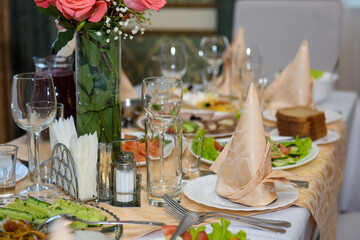 A table with dishes of food for the reception of guests. Festive eating at a banquet party.