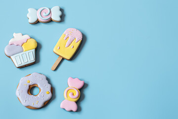 Flat lay bright glazed cookies of different shapes.