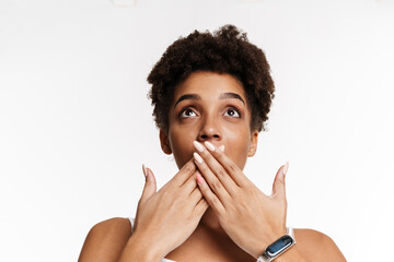 Young black woman expressing surprise and covering her mouth