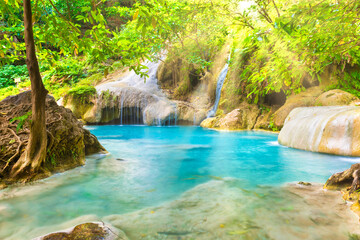 Naklejka premium Tropical landscape with beautiful waterfall, emerald lake and rocks in wild jungle forest. Erawan National park, Kanchanaburi, Thailand