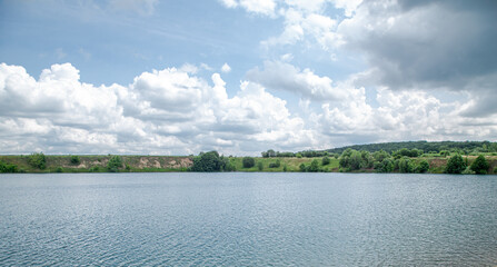 Beautiful landscape, river, forest and clouds on a sunny day.