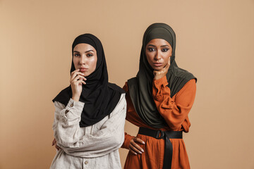 Young muslim women in hijab posing and looking at camera