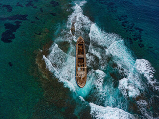 Aerial drone shot of cargo shipwreck in Paphos with waves Cyprus island storm Mediterranean sea
