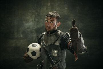 Portrait of one brutal bearded man, medeival warrior or knight with dirty wounded face holding ball...