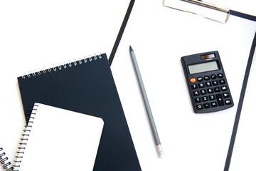 Calculator, paper money and notebook isolated on white background. Concept of debt management, payment of taxes and investing