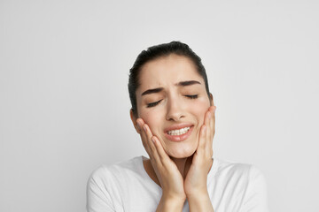 woman holding face toothache discontent discomfort