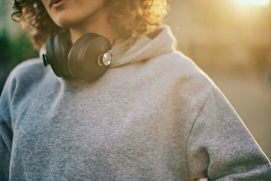 Cutout Picture Of A Young Woman Standing Outdoors With Headphones Around Her Neck. Music Is All Around If You Want To Hear It.