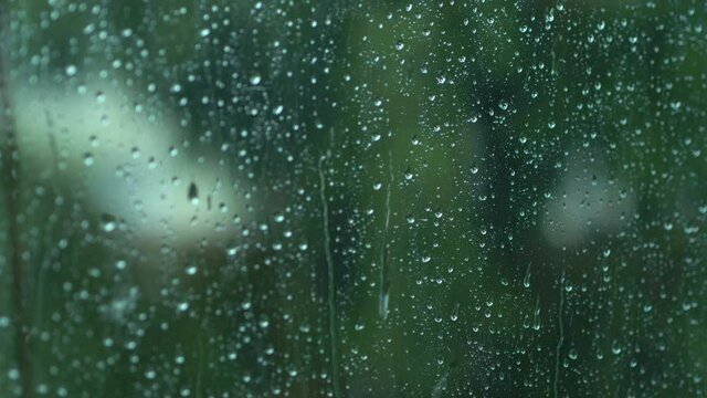 Rain drops on the window glass in 4k slow motion 60fps