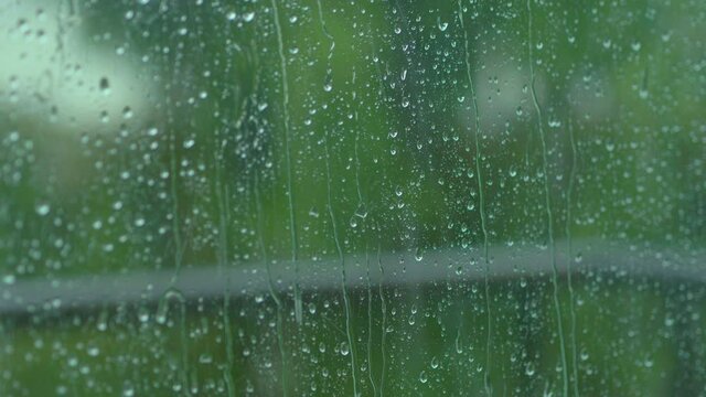 Rain drops on the window glass in 4k slow motion 60fps