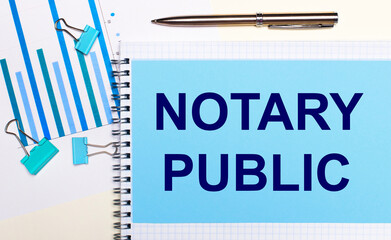 On a light background - light blue diagrams, paper clips and a sheet of paper with the text NOTARY...
