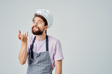 a man in a chef's uniform gesturing with his hands Professional culinary industry