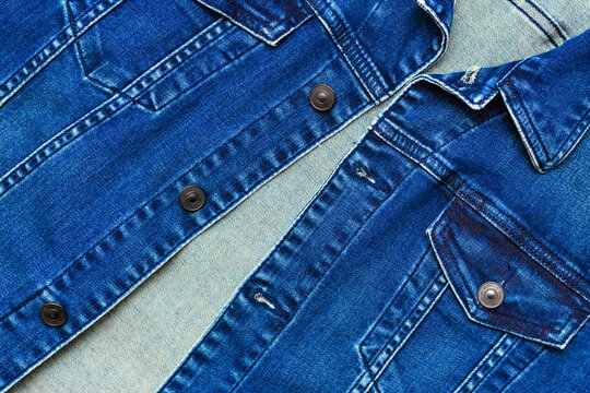 Close up view of denim jacket with buttons and pockets. Blue denim jacket, top view. Men's denim jacket with classic stitching.