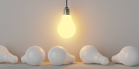 Single glowing lightbulb on top of white bulbs over bright background, creativity, uniqueness or standing out concept