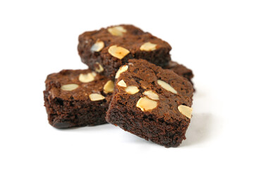 pieces of fresh homemade chocolate brownie, square shape, with sliced almond on top isolated on white background