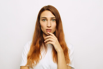 Fototapeta premium A young woman looks scared, worried, surprised or upset.