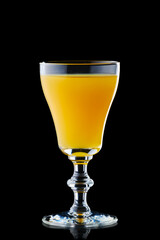 Glass with vodka and orange juice isolated on black