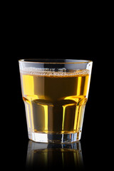 Fresh apple juice in rocks glass isolated on black