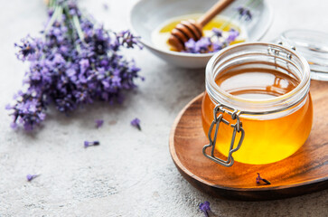 Jars with honey and fresh lavender flowers