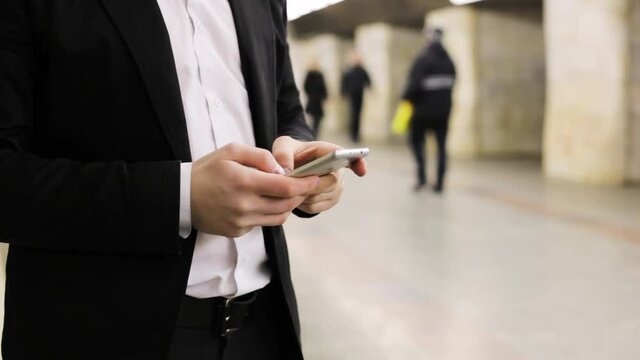 Close-up male hands on the phone are typing a message.