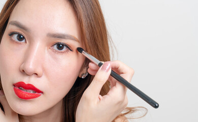 Fototapeta premium portrait beautiful woman with makeup eye brush