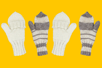 Knitted mittens isolated on a yellow background