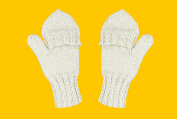 Knitted mittens isolated on a yellow background