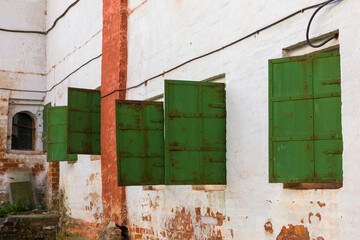 Green shutters on the old wall.