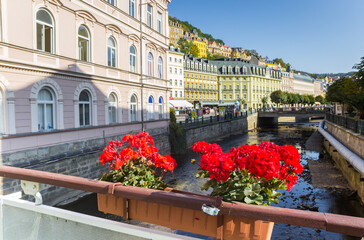 Red flowers on the bridge in the historic center of Karlovy Vary, Czech Republic