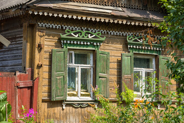 Wooden house decoration. Old house in Kaluga. Green shutters. 