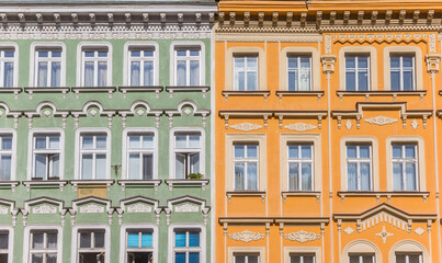 Green and orange facades of historic houses in Karlovy Vary, Czech Republic