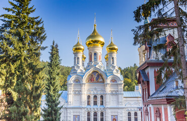 Fototapeta na wymiar Front facade and golden domesof the Russian church in Karlovy Vary, Czech Republic