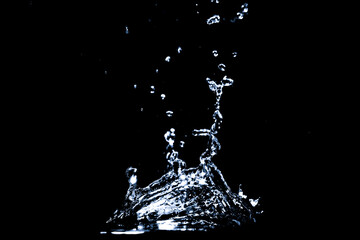 Splashing water on a black background. Water splashes on a black background. diffused water abstract