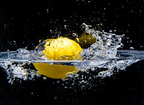 Lemon water splash with black background