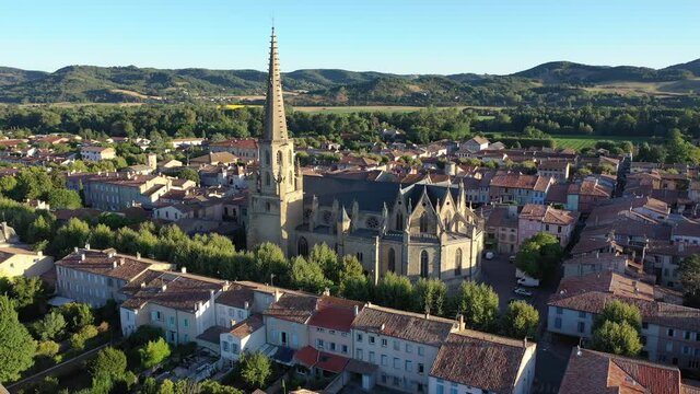 View from drone of houses of Mirepoix town and cathedral of St-Maurice at sunny summer day, France