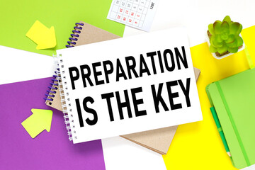 PREPARATION IS THE KEY. notepad on a colorful background. white purple and yellow background.