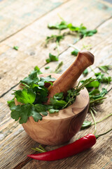 Different herbs on a old wooden table .