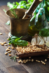 Ingredients for making pesto on a wooden table.